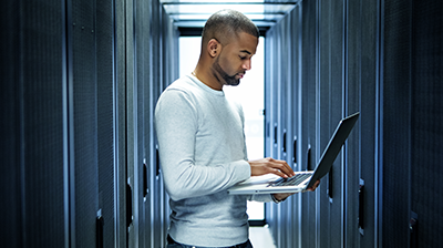 3 Commercial Lines Technology Trends to Look for in 2022 Man using a laptop in a hall of cabinets